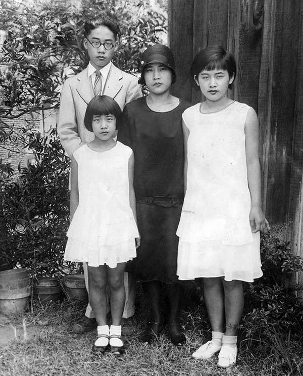 Photograph caption dated September 3, 1929 reads, "Photo shows Mrs. Karuko Rokumoto, the crash victim's widow, and her three children bereft by the tragedy. At left, William Rokumoto, in foreground Grace, left, and Mary Rokumoto. Mother and son are prosecution witnesses." (Photo courtesy LAPL0