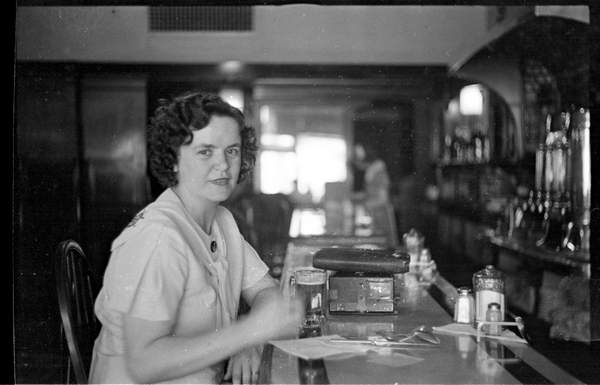 Aggie hoists a brew c. 1920s.